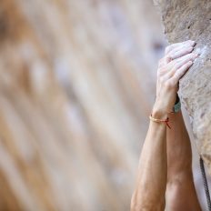 Close up climber's hands on a cliff